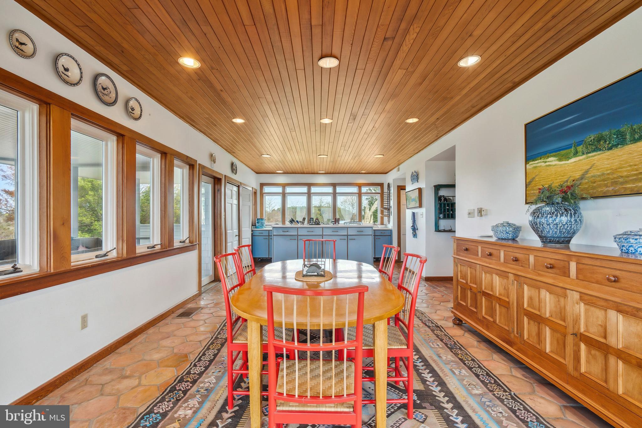 26319 Chanticleer Road Oxford, MD 21654 - Photo 26 of 55 a dining room with furniture a rug and wooden floor