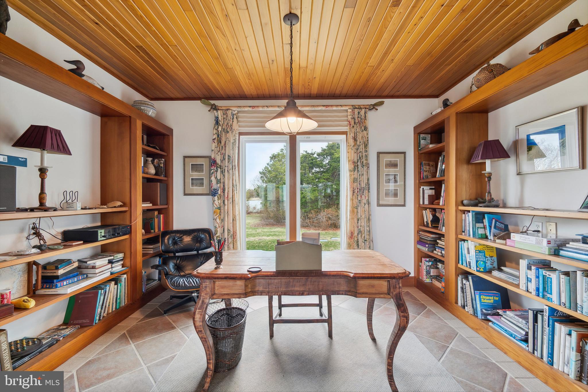 26319 Chanticleer Road Oxford, MD 21654 - Photo 27 of 55 a work room with furniture and a book shelf