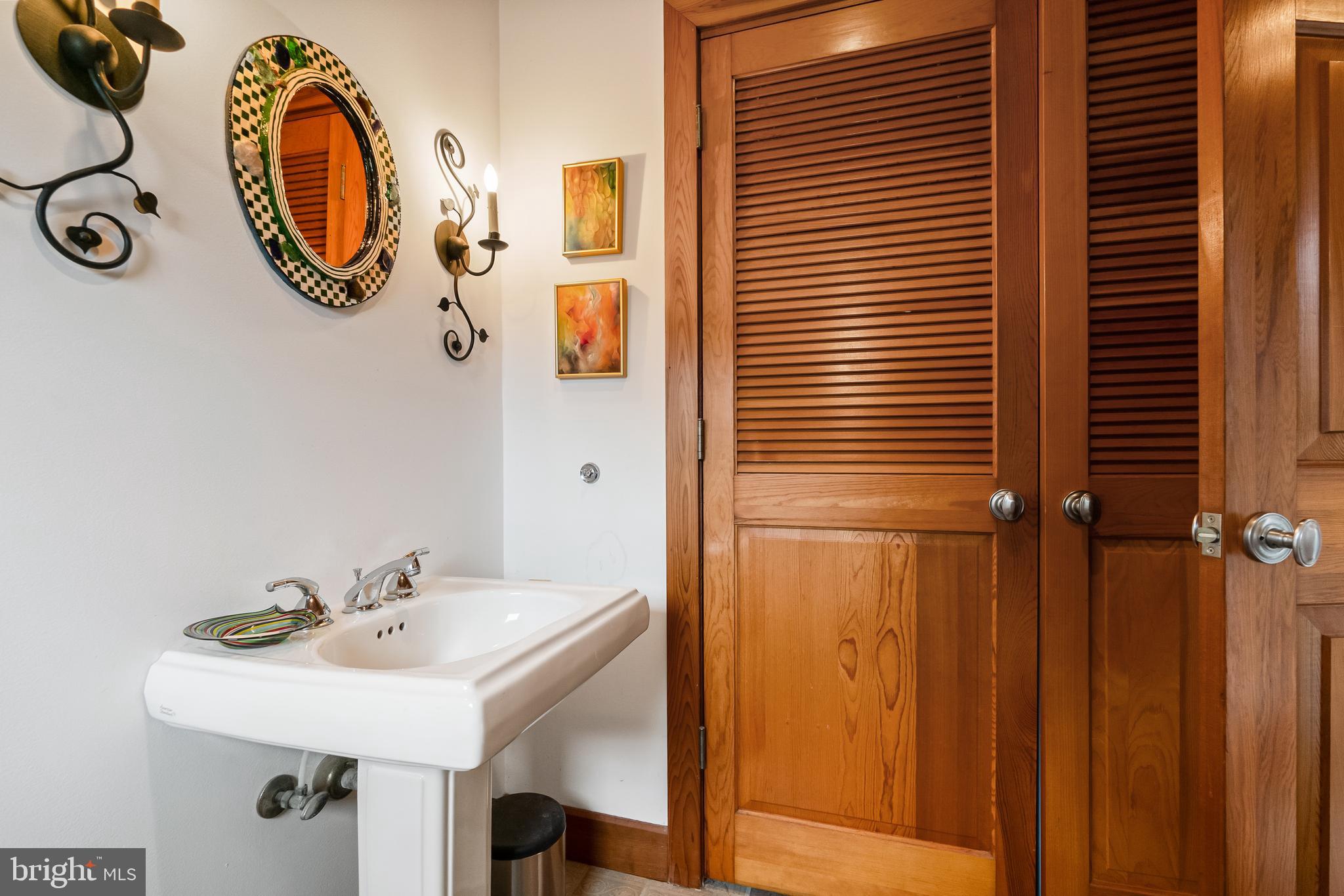 26319 Chanticleer Road Oxford, MD 21654 - Photo 31 of 55 a bathroom with a sink and a mirror
