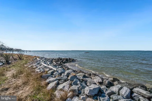 a living room with furniture wooden floor and large window