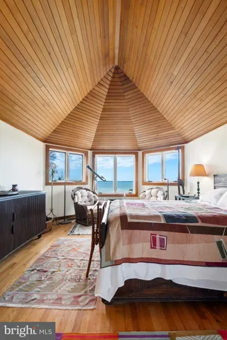 a blue couch sitting next to a window