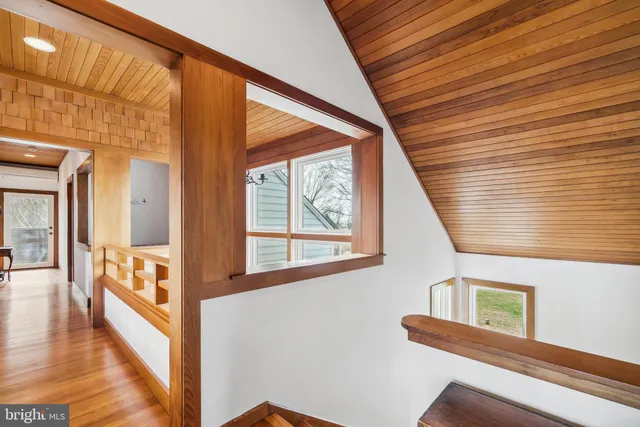 a bedroom with two beds and large window