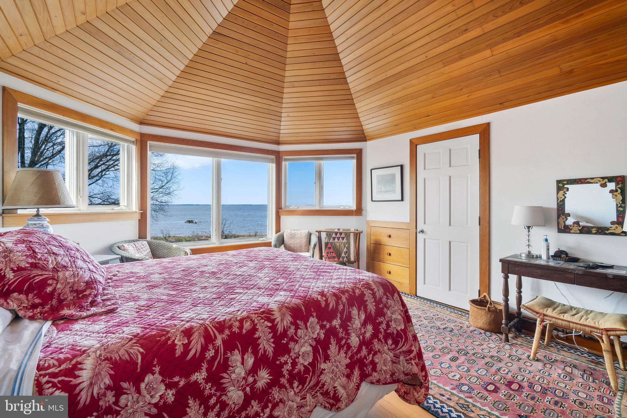 26319 Chanticleer Road Oxford, MD 21654 - Photo 48 of 55 a bedroom with a bed a table and chair