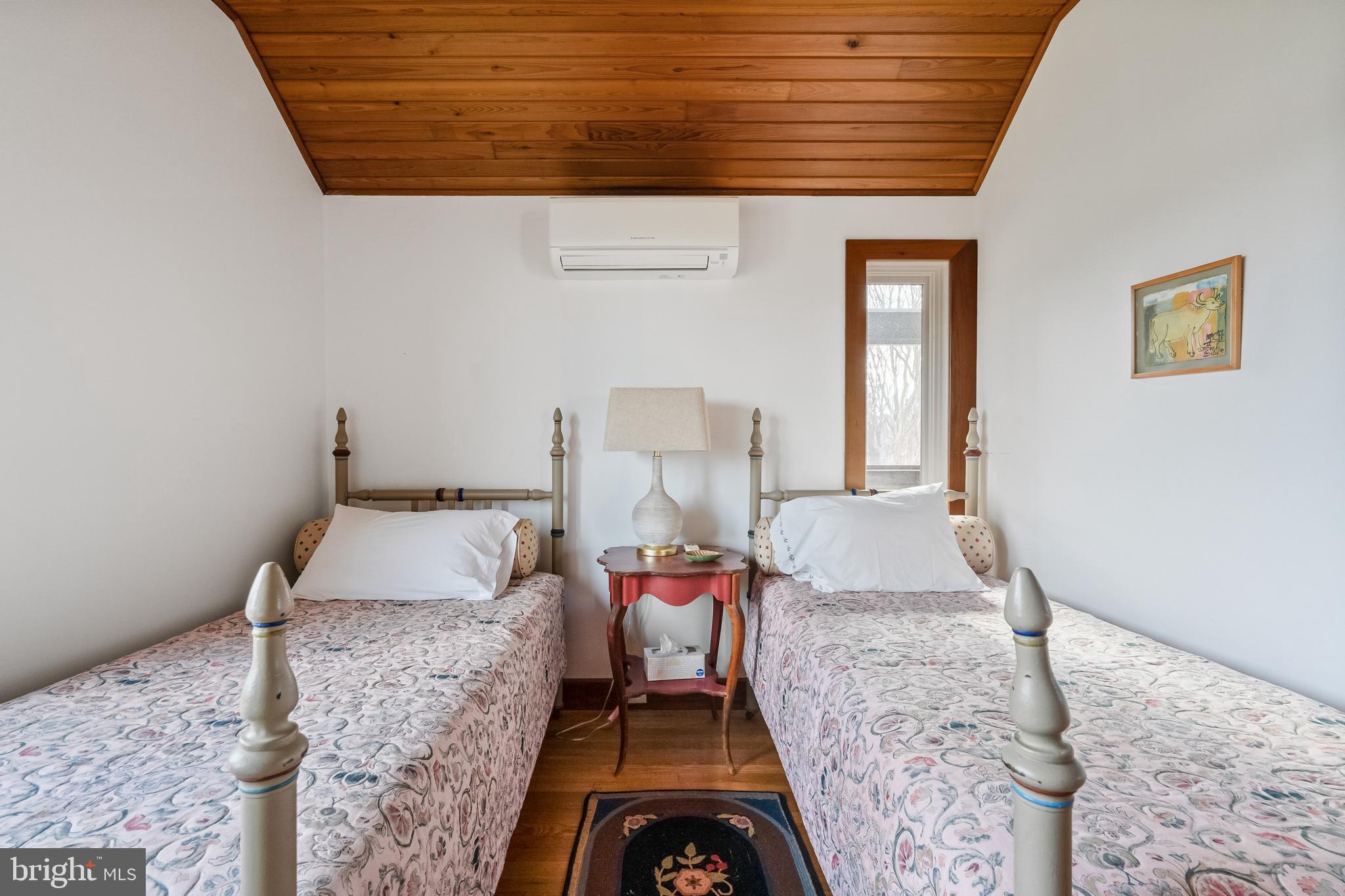 26319 Chanticleer Road Oxford, MD 21654 - Photo 51 of 55 a bedroom with a bed and wooden floor