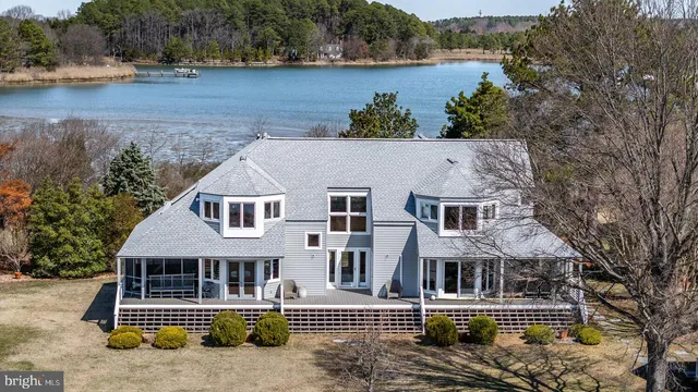 an aerial view of a house with a lake view
