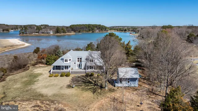 an aerial view of a house with outdoor seating