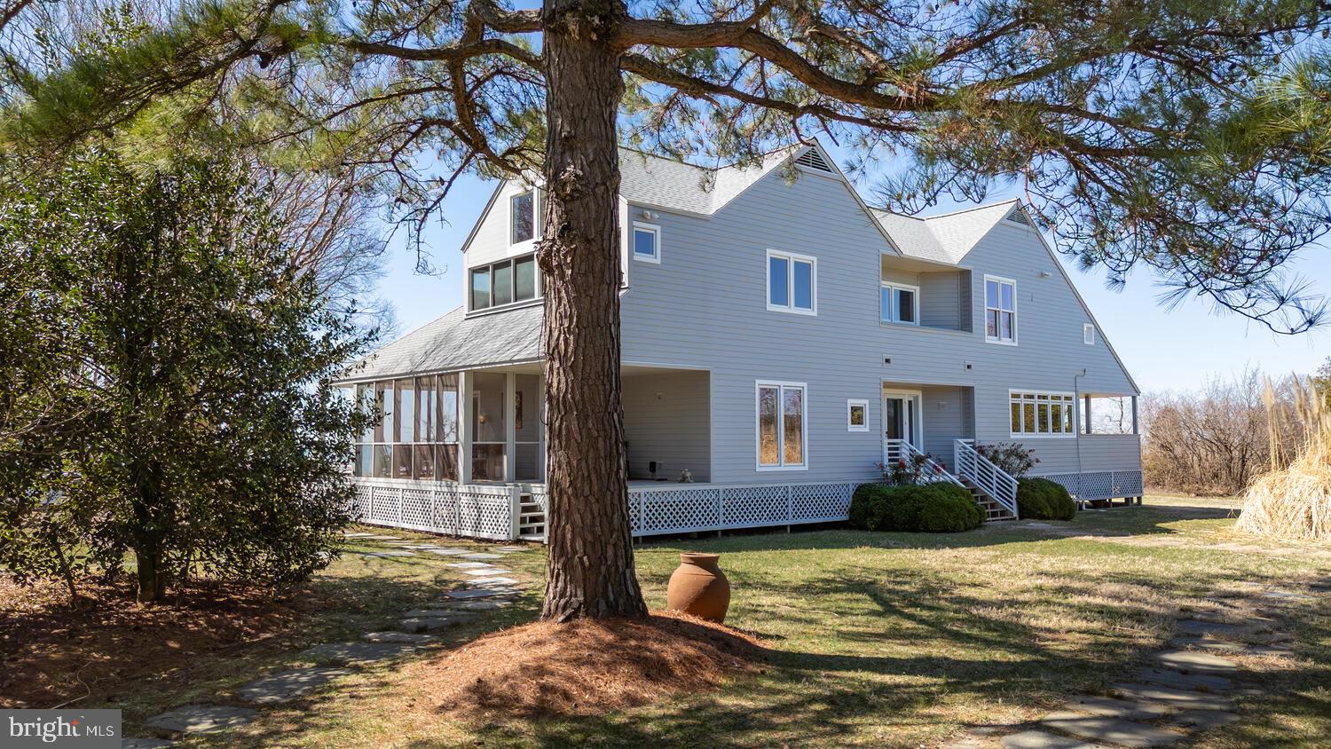 26319 Chanticleer Road Oxford, MD 21654 - Photo 10 of 55 a front view of a house with a yard covered in snow