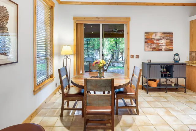 a view of a dining room with furniture and a potted plant