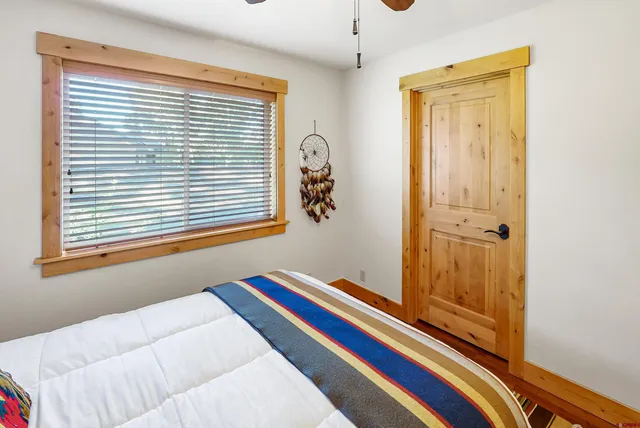 a bedroom with a bed and a window