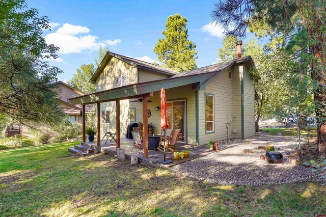 a view of a house with backyard porch and sitting area