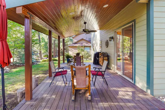 a view of a patio with table and chairs and wooden floor