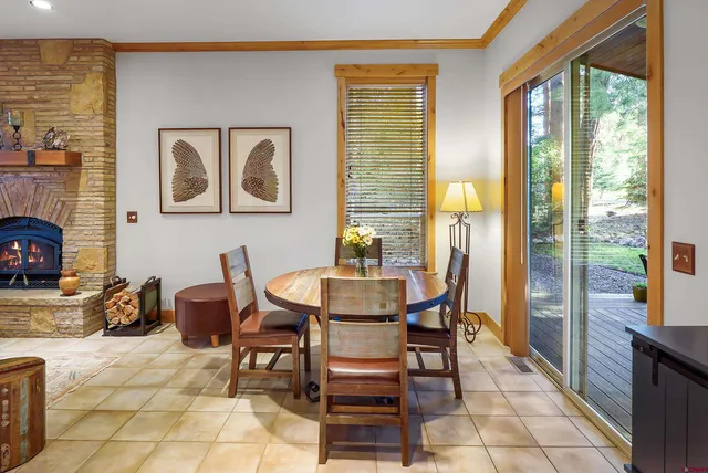 a dining room with furniture and large windows
