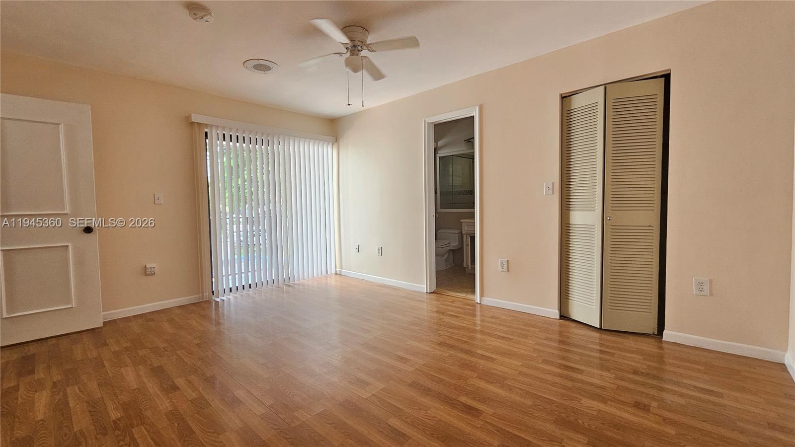 13454 Southwest 62nd Street, Unit 101O Miami, FL 33183 - Photo 13 of 15 a view of an empty room with wooden floor