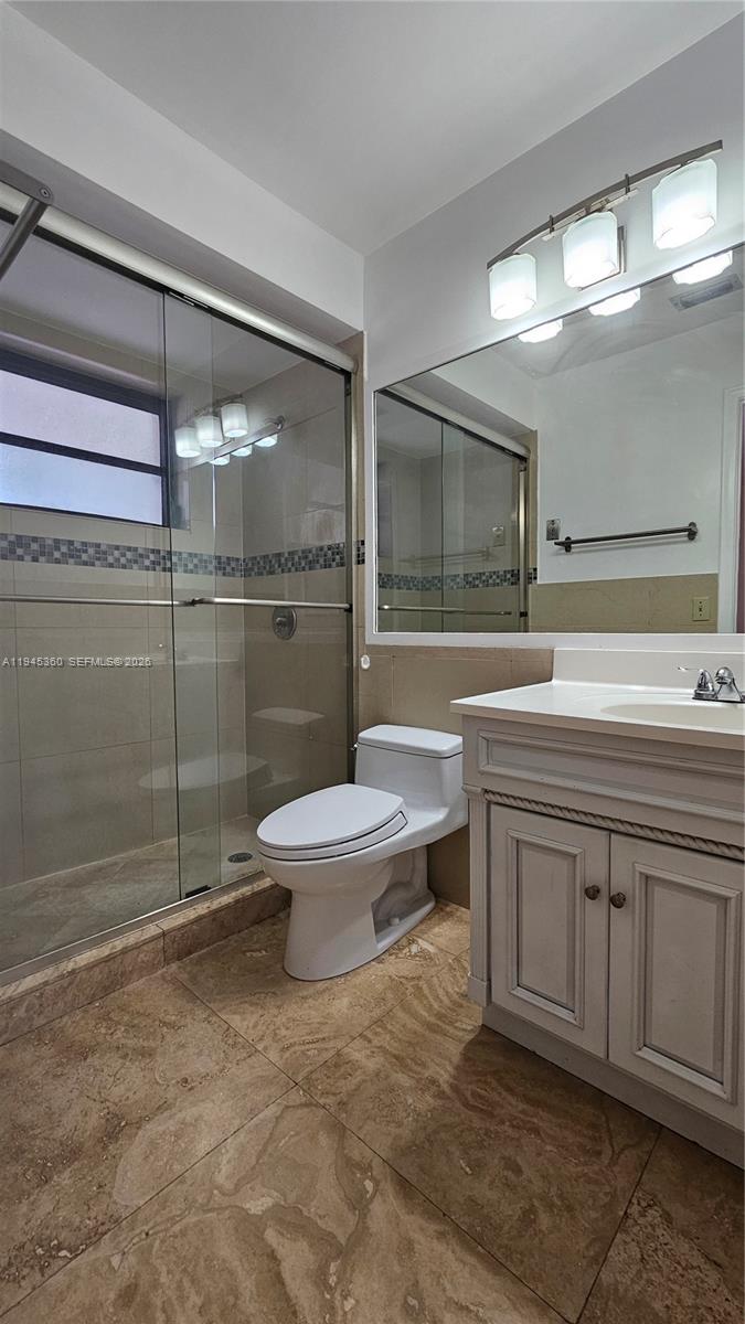 13454 Southwest 62nd Street, Unit 101O Miami, FL 33183 - Photo 15 of 15 a bathroom with a sink toilet and shower