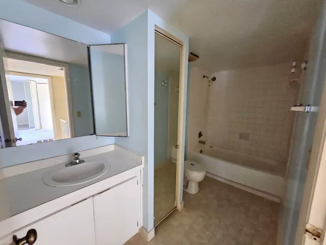 a bathroom with a toilet and a bath tub
