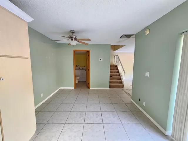 a view of a kitchen with a sink and a refrigerator