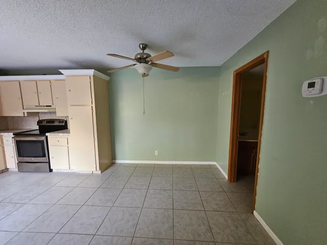 a kitchen with a refrigerator a oven and a sink