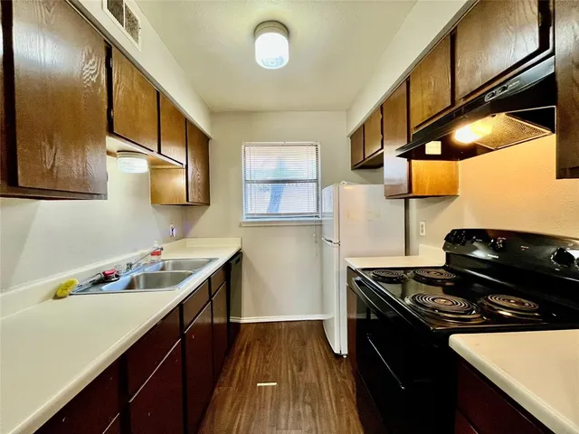 a kitchen with stainless steel appliances a sink dishwasher stove and refrigerator
