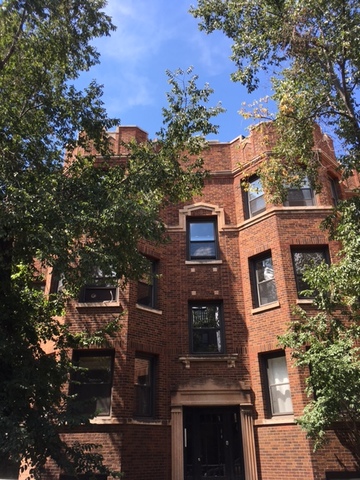 front view of a house with a tree