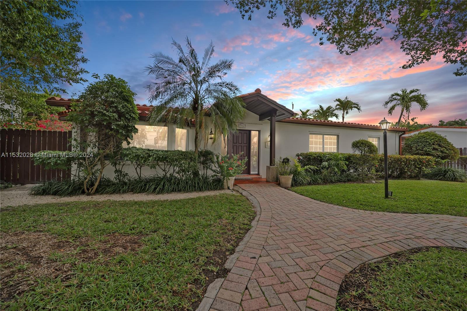 255 Ridgewood Road Key Biscayne, FL 33149 - Photo 18 of 18 a front view of a house with garden