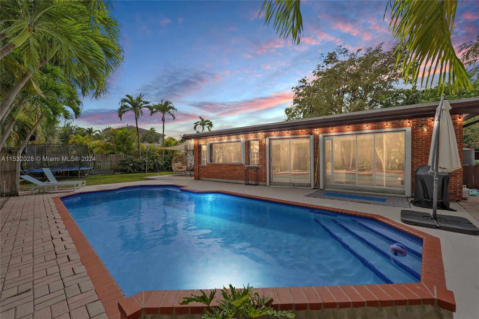 255 Ridgewood Road Key Biscayne, FL 33149 - Photo 2 of 18 a view of swimming pool with a patio