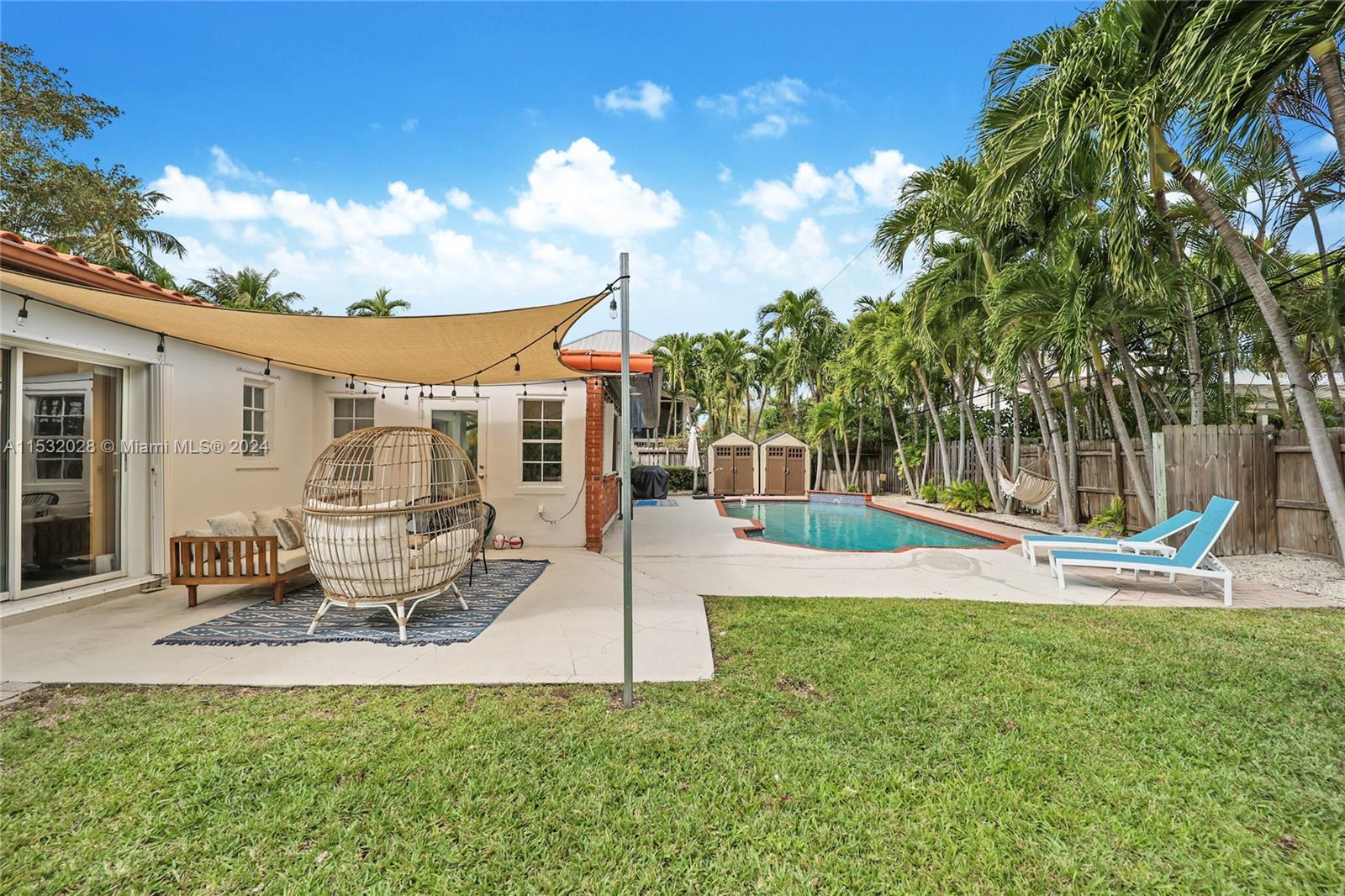 255 Ridgewood Road Key Biscayne, FL 33149 - Photo 3 of 18 a view of a house with swimming pool and sitting area