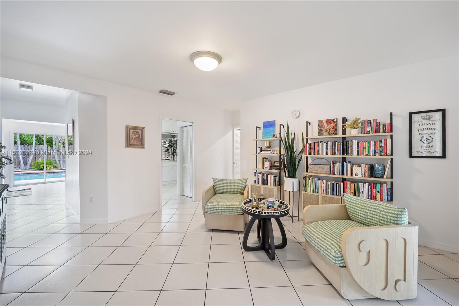 255 Ridgewood Road Key Biscayne, FL 33149 - Photo 4 of 18 a living room with furniture and a book shelf