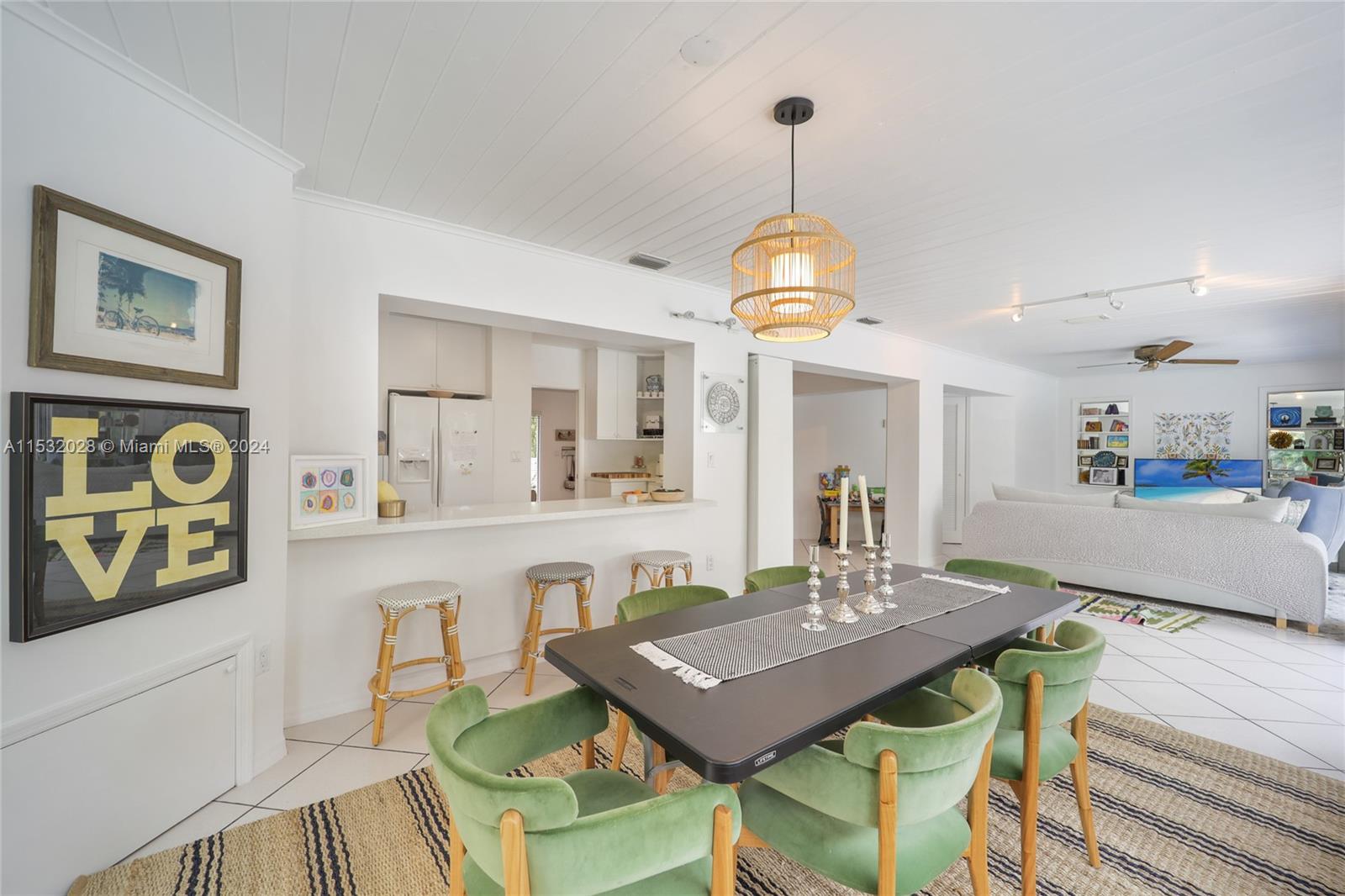 255 Ridgewood Road Key Biscayne, FL 33149 - Photo 6 of 18 a view of a dining room and livingroom with furniture wooden floor a chandelier
