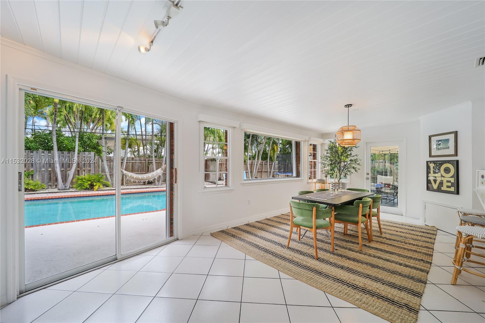 255 Ridgewood Road Key Biscayne, FL 33149 - Photo 7 of 18 a dining room with wooden floor and a table