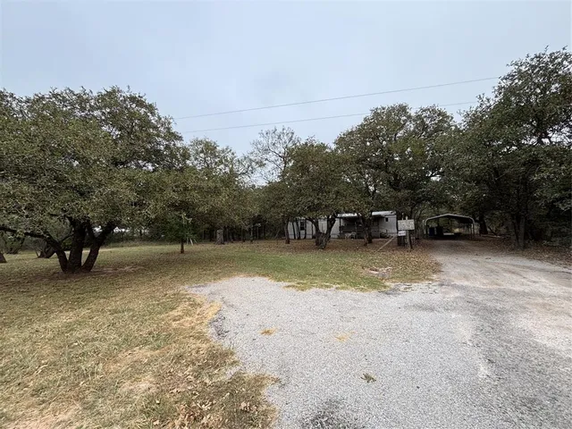 a view of a yard with a table and chair