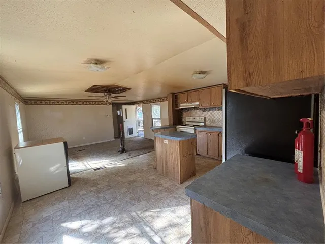 a kitchen with refrigerator and cabinets