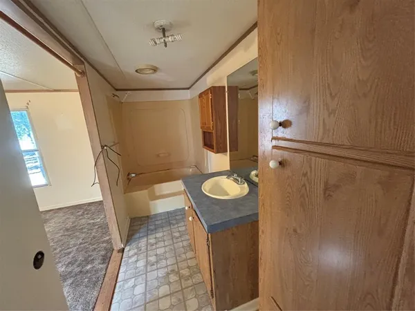 a bathroom with a sink and mirror