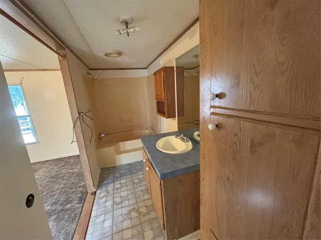 a kitchen with refrigerator and cabinets