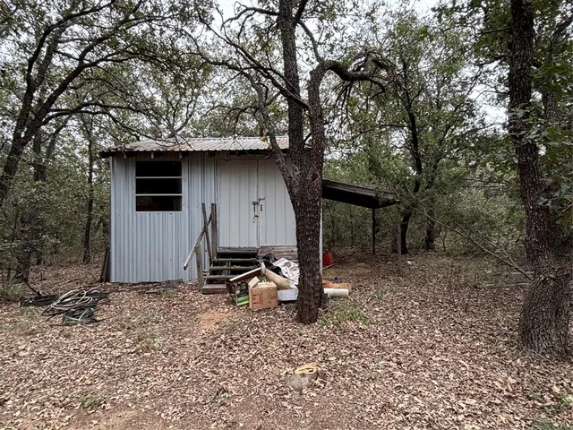 a backyard of a house with table and chairs