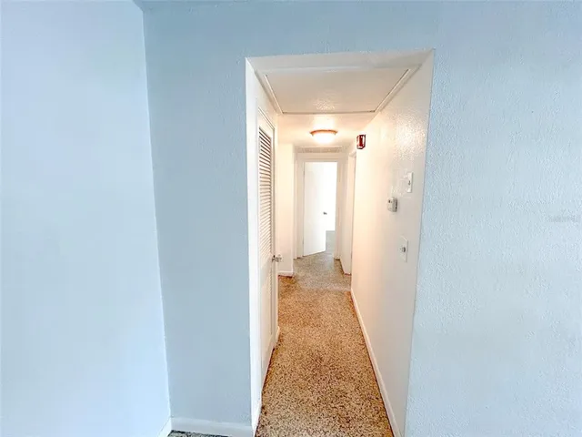 a hallway with a door and couch