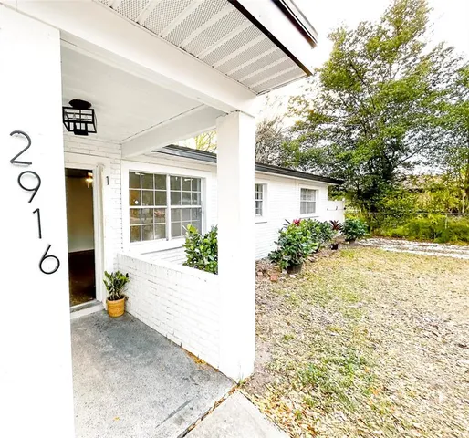 a view of a porch with potted plants