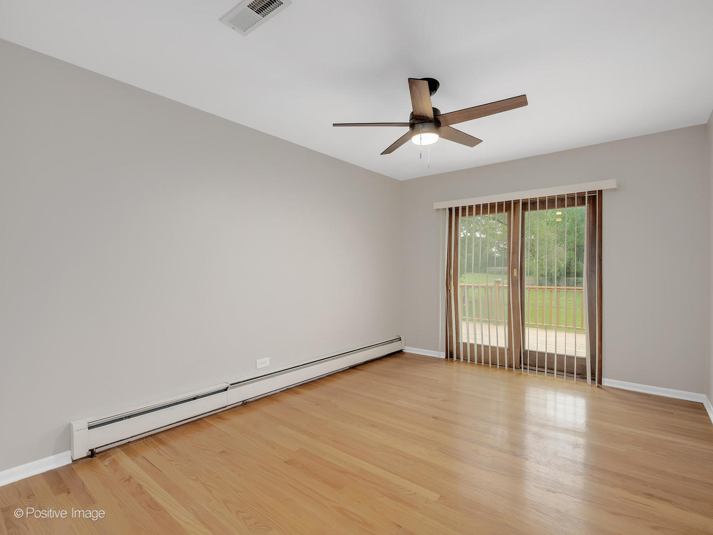 335 Oldfield Road Darien, IL 60561 - Photo 16 of 33 an empty room with wooden floor and windows