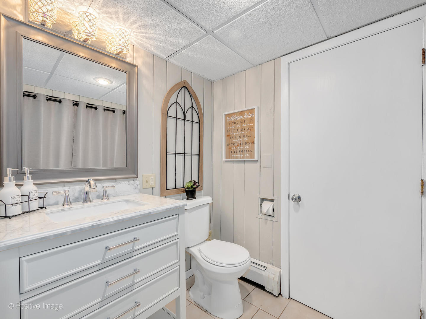 335 Oldfield Road Darien, IL 60561 - Photo 22 of 33 a bathroom with a sink a toilet and a mirror