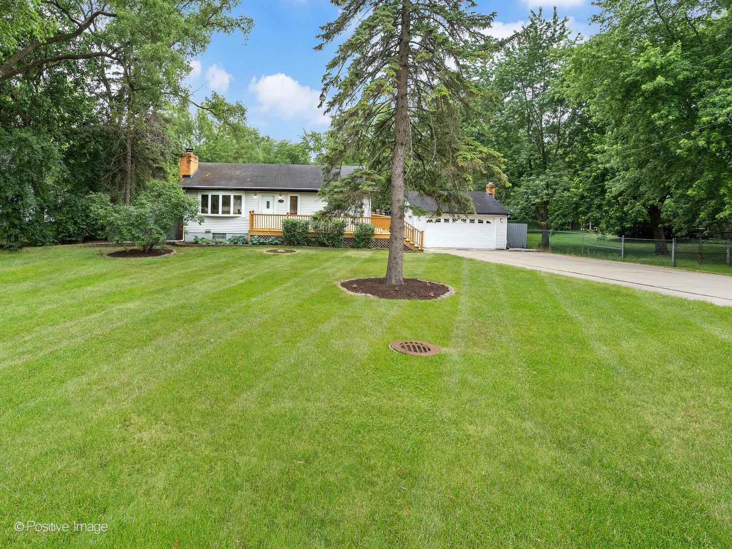 335 Oldfield Road Darien, IL 60561 - Photo 33 of 33 a view of a house next to a big yard and large trees