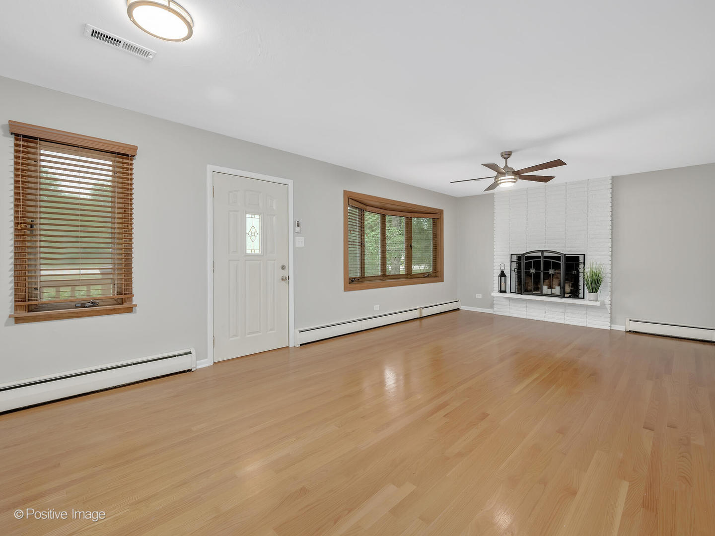 335 Oldfield Road Darien, IL 60561 - Photo 4 of 33 a view of a livingroom with a fireplace and window