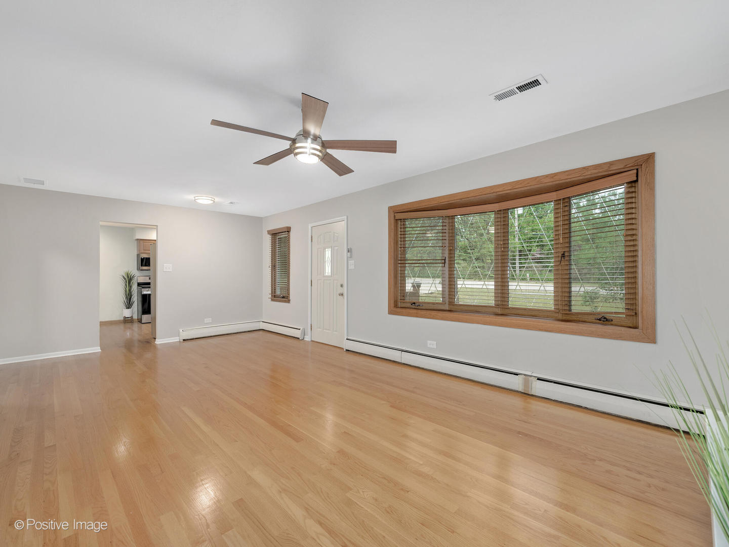 335 Oldfield Road Darien, IL 60561 - Photo 8 of 33 a view of an empty room with a window and a kitchen
