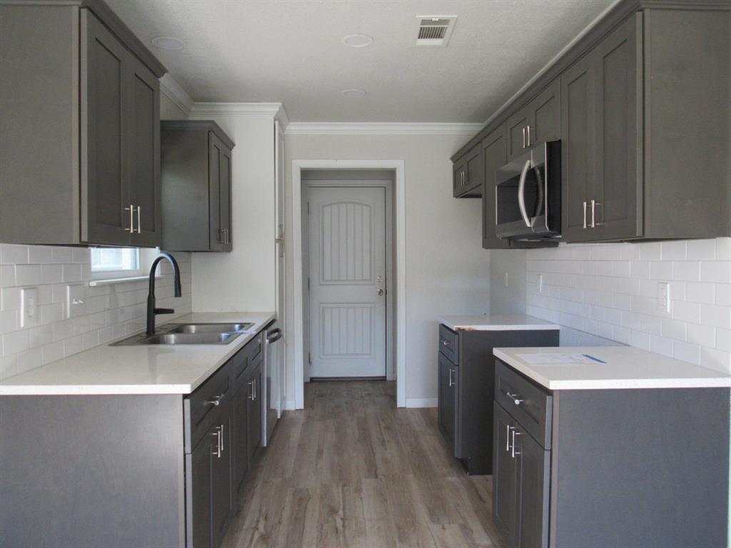 2104 Dan Rowe Street Waco, TX 76704 - Photo 5 of 14 a kitchen that has a sink and a stove in it