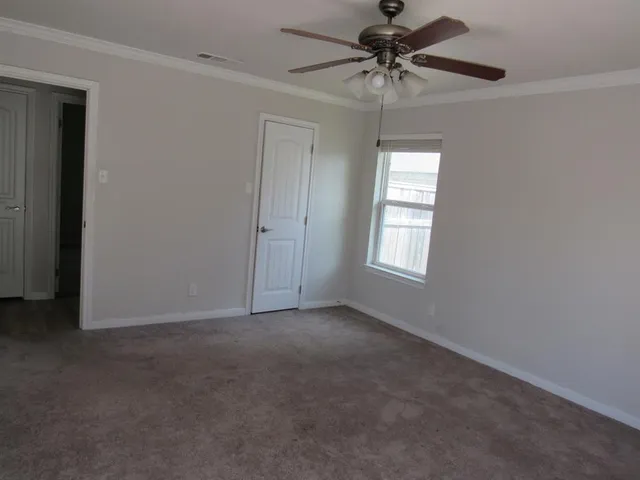 a view of a livingroom with a ceiling fan and window