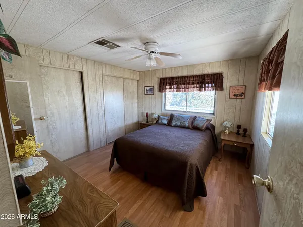 a bedroom with a bed mirror and window