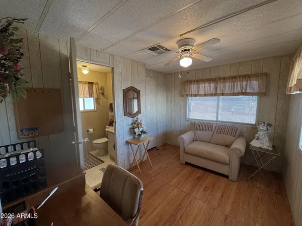 a living room with furniture a ceiling fan and a window