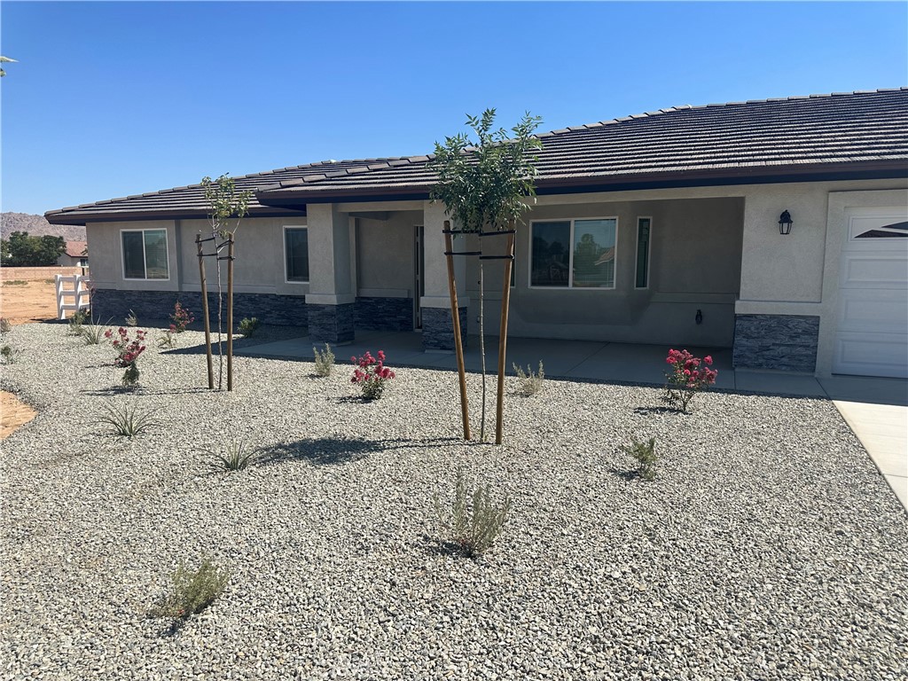 15073 Temecula Road Apple Valley, CA 92307 - Photo 1 of 1 a backyard of a house with table and chairs