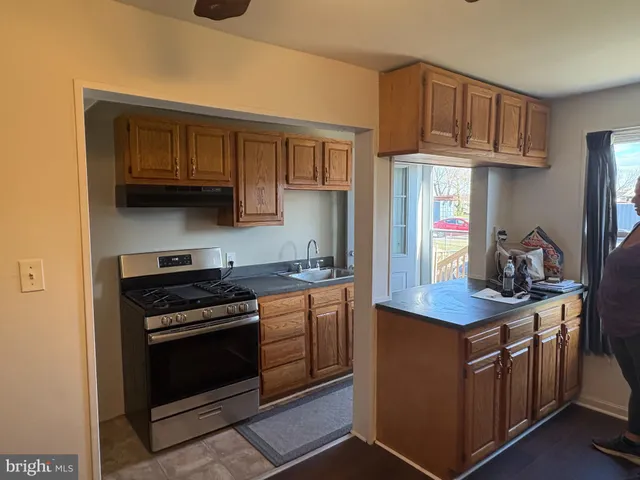 a kitchen with stainless steel appliances granite countertop a stove and a sink