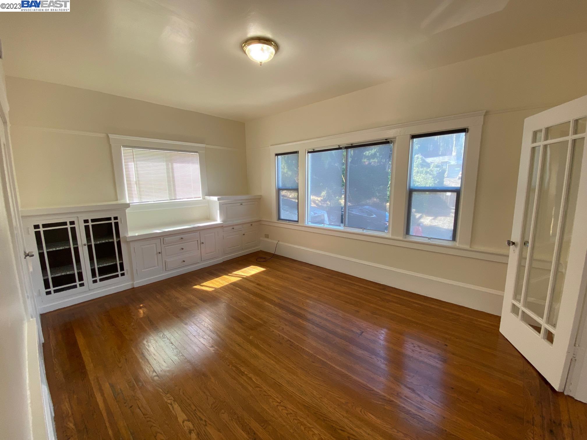 Ivy Hill Oakland, CA 94606 - Photo 14 of 19 wooden floor in an empty room with a window