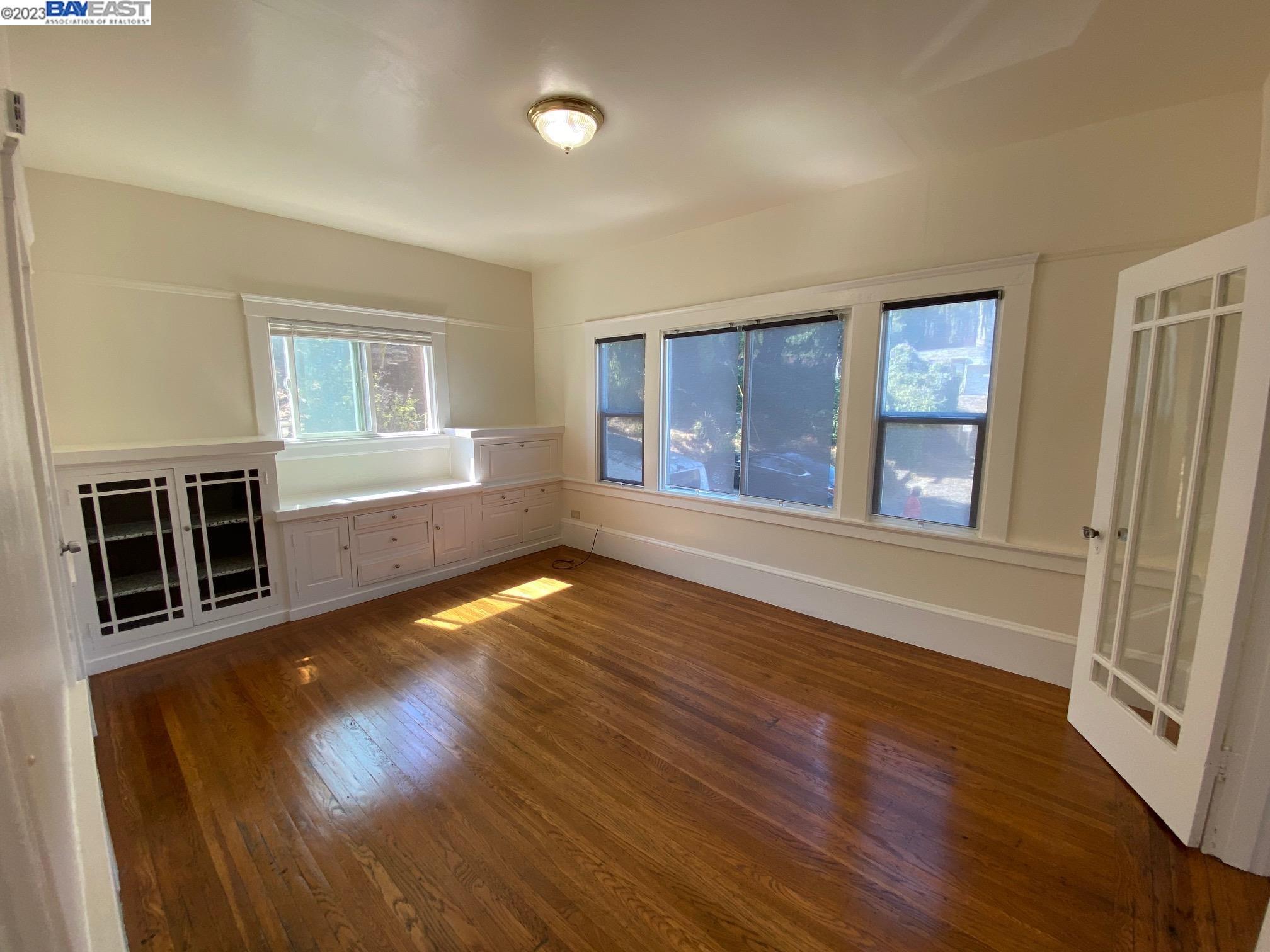 Ivy Hill Oakland, CA 94606 - Photo 15 of 19 wooden floor in an empty room with a window