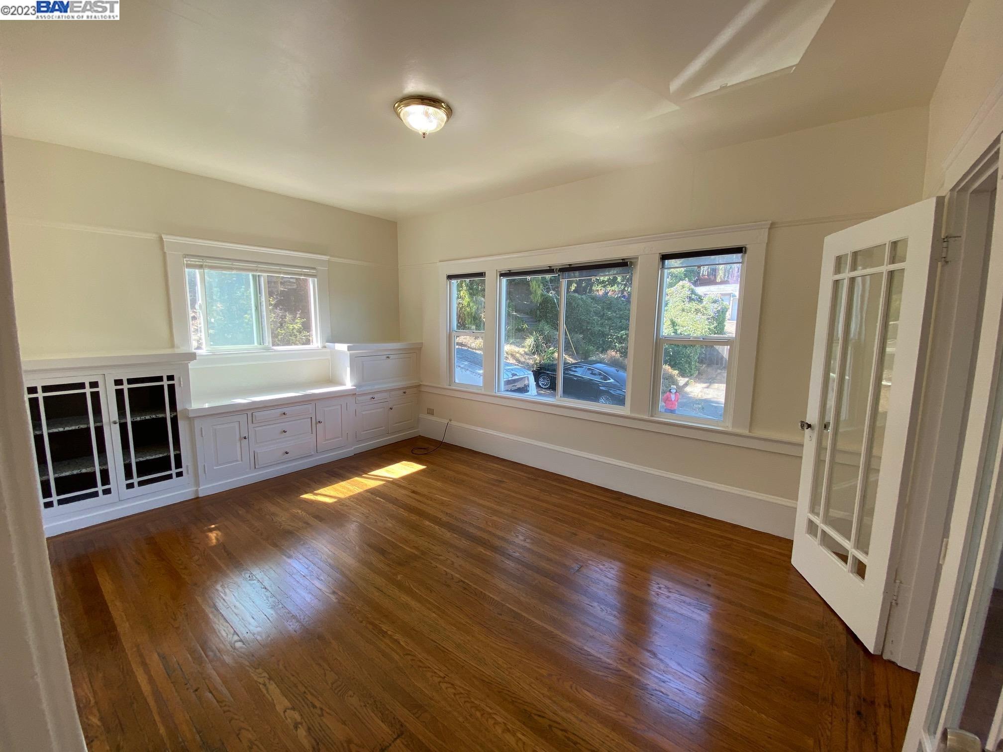 Ivy Hill Oakland, CA 94606 - Photo 16 of 19 wooden floor in an empty room with a window